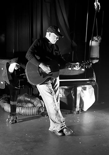 Calvin Gilmore backstage leaning on a piano