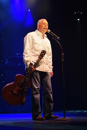 Calvin Gilmore performing on a blue-lit stage