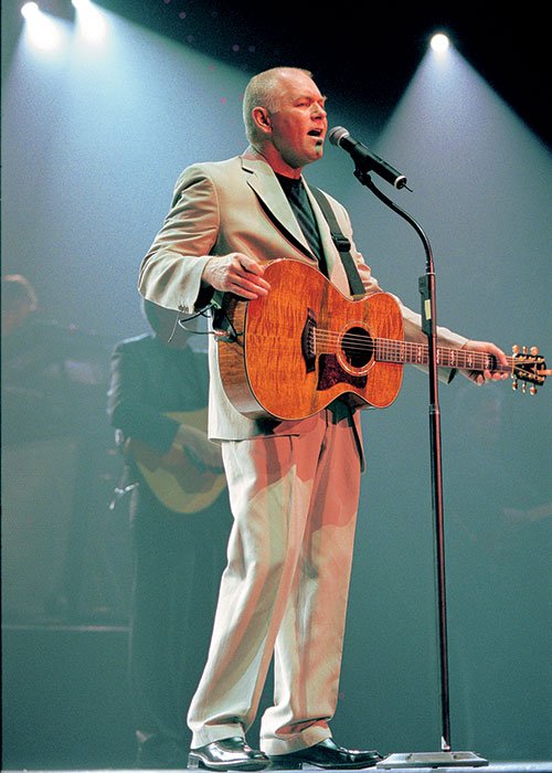 Calvin Gilmore full-body portrait with guitar